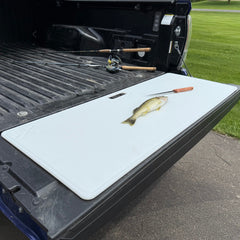 Big Fish Cutting Board on tailgate — hero product photo