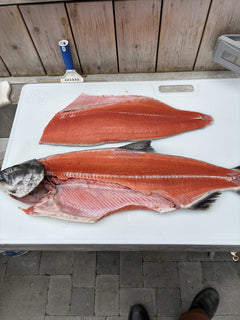 Sockeye salmon fillets and head on Big Fish cutting board