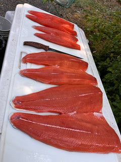 Six sockeye salmon fillets fanned with knife on Big Fish board